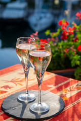 Romantic wedding party with two glasses of white cold champagne and view on yachts and houses of Port Grimaud, French riviera, France