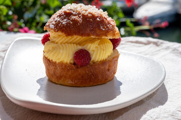 Tarte tropezienne or La Tarte de Saint-Tropez - dessert pastry consisting of filled brioche with cream and fresh berries.