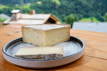 Cheese collection, French cheese tomme de savoie and french mountains village in Haute-Savoie on...
