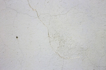 Cracked gray plaster on wall.