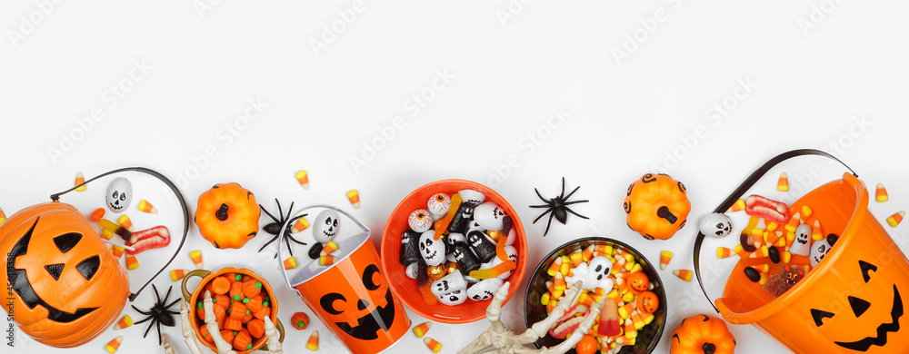 Poster halloween trick or treat bottom border with jack o lantern pails and a variety of candy. top view on