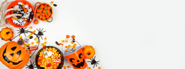 Halloween trick or treat corner border with jack o lantern pails and a selection of candy. Above...