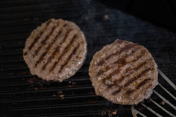 cooking beef patties on grill