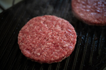 cooking beef patties on grill