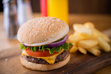 fresh cheese hamburger on wooden cutting board