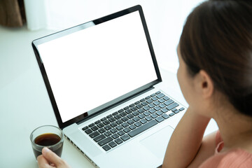 Mockup laptop screen isolated with clipping path. Asian young woman working at home in living room.