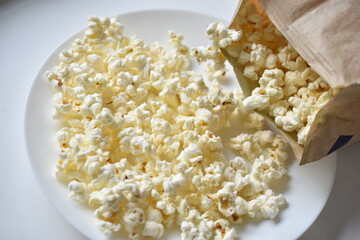A bag of popcorn open on a plate in the kitchen