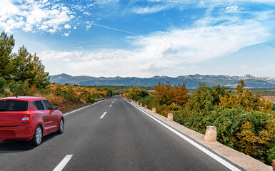 Red car on a scenic road