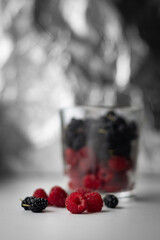 Raspberries and mulberries in a glass. View of the berries and a glass of berries.