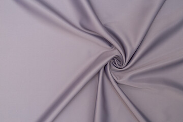 The texture is an abstract background made of gray fabric. Drapery and pleats.