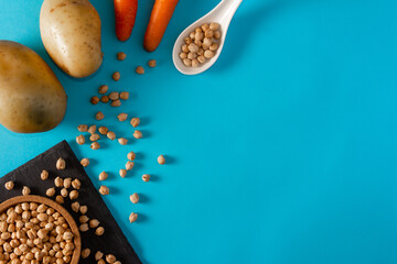 Urban garden ingredients. Potatoes, carrots and chickpeas. Flat lay. Copy space.