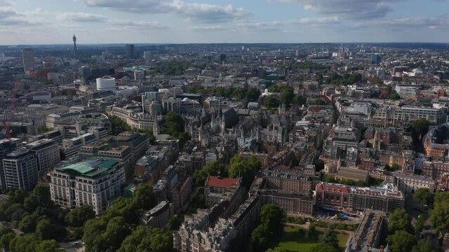Aerial view of large city. Historic Royal Courts of Justice buildings complex and buildings in Temple Gardens among newer houses. London, UK
