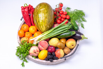 Fruits and vegetables in a wooden tray isolated on white background background