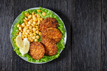 baked pork patties with lupin beans on a plate
