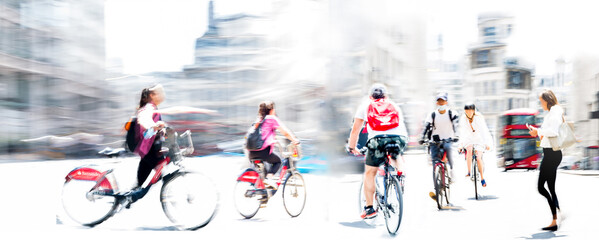 Obraz premium Cyclists on the London's streets. Motion blur image, wide panorama. Commuters, healthy lifestyle, Business concept illustration, business people, modern life style