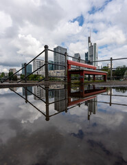 Frankfurt, Germany - June 4, 2021: the famous red bench in front of the frankfurt skyline at the...