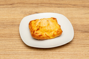 Quesadilla bun with onion and melted cheese on pizza bread