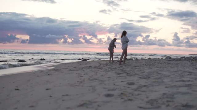 The girls are photographed by the sea on the Sunrise.