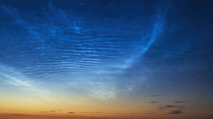 Noctilucent clouds before sunrise, cloudlike atmospheric phenomena visible in twilight. Highest clouds in atmosphere