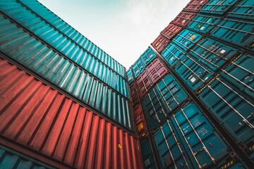 Cargo container for overseas shipping on high stack look up from ground . Logistics supply chain...