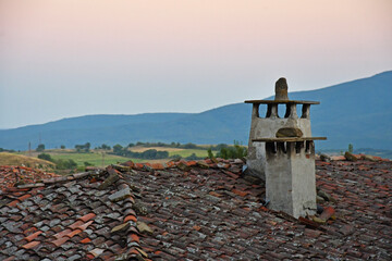 A roof of an old house at dusk