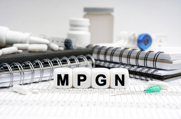 On the table are diaries, medicines and cubes with the inscription - MPGN