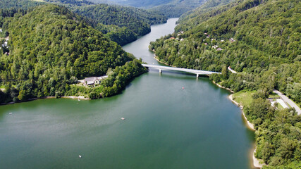 View of the Ruzin reservoir on the outskirts of Kosice. Lake bridge. Boats in the water. River and trees on the mountains. Slovakia. Europe