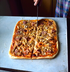 cooking pizza at home in the kitchen, close-up