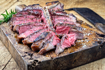 Traditional dry aged barbecue wagyu porterhouse beef steak sliced with herbs and spice served as...