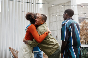 Obraz premium Multi-ethnic group of modern young people greeting each other at rooftop party, copy space