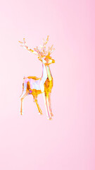 Christmas decoration deer figurine on a pink background. Christmas composition with holographic toy deer. Festive holiday concept. Copy space
