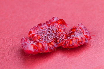 ripe red raspberries on red paper