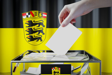 Baden-Wurttemberg flag, hand dropping ballot card into a box - voting/ election in Germany concept - 3D illustration