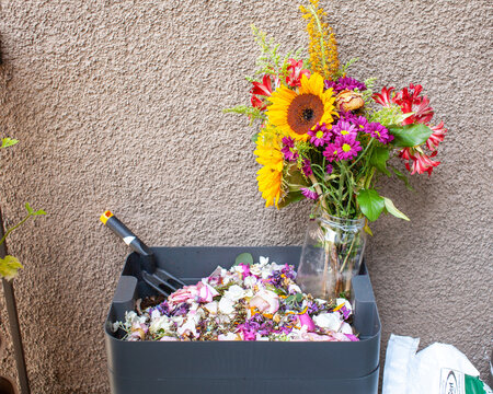 Worms can eat flowers too! A vermicomposting system (worm composter) sits on a balcony. Worms eat food scraps and produce worm castings and worm tea to be used as fertilizer. Redirect waste.