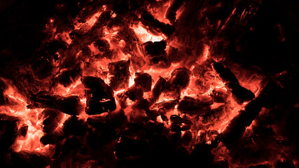 Glowing red hot coals macro textured background. fire pit bed of burning coals abstract wallpaper