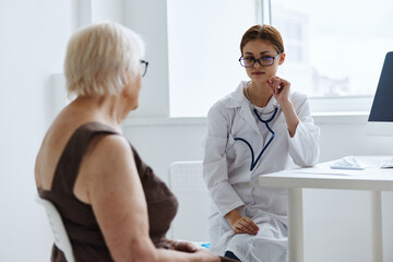 elderly woman examination by a doctor medical office