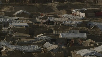 Afghanistan scene - day time scene from Kabul city -tele photo scene of shanty refugee housings and tents - from slight over head camera position