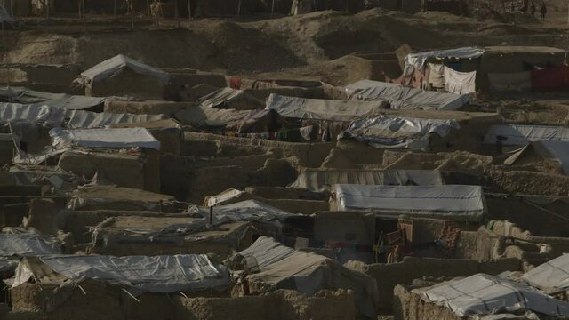 Afghanistan scene - day time scene from Kabul city -tele photo scene of shanty refugee housings and tents - from slight over head camera position