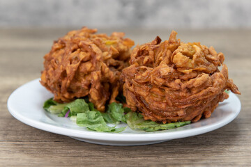 Deep fried bhaje onion blossoms is perfect appetizer from Indian restaurant cooked and seasoned perfectly