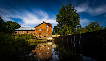 Naklejka na ściany i meble Water mill in a village in the Eastern Townships of Quebec, Canada