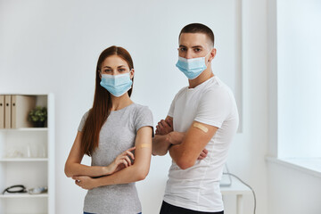Fototapeta na wymiar women and men wearing medical masks and with adhesive tape on their shoulders in the hospital covid passport