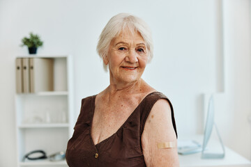 old woman plaster on shoulder covid passport immunization safety