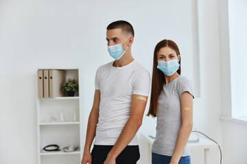 man and woman wearing medical masks health care vaccine passport