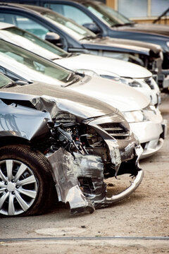 Damaged Cars In Line At The Auto Repair Shop