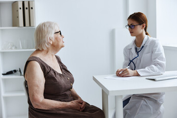 Fototapeta premium old woman patient consults with a doctor health care