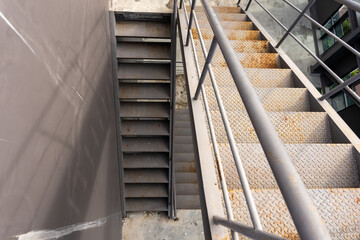 The old iron staircase had handrails to climb the deck of the building for repairs and maintenance