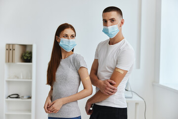 Fototapeta na wymiar young couple wearing medical masks covid vaccination passport