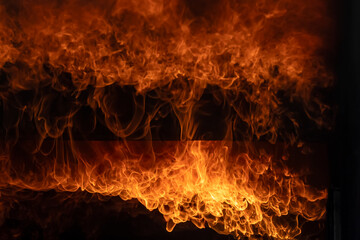 Fototapeta premium Burning red hot sparks rise from large fire,Close Up Fire flames from gas explosion on black background.