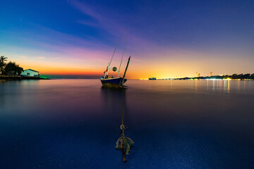 Twilight Silhouette Fisherman boat at sunset . Fishermen fishing boat in beach side Thailand.