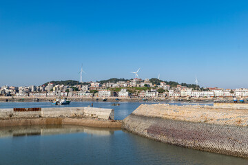 The wharf of the fishing village and the dam made of stones